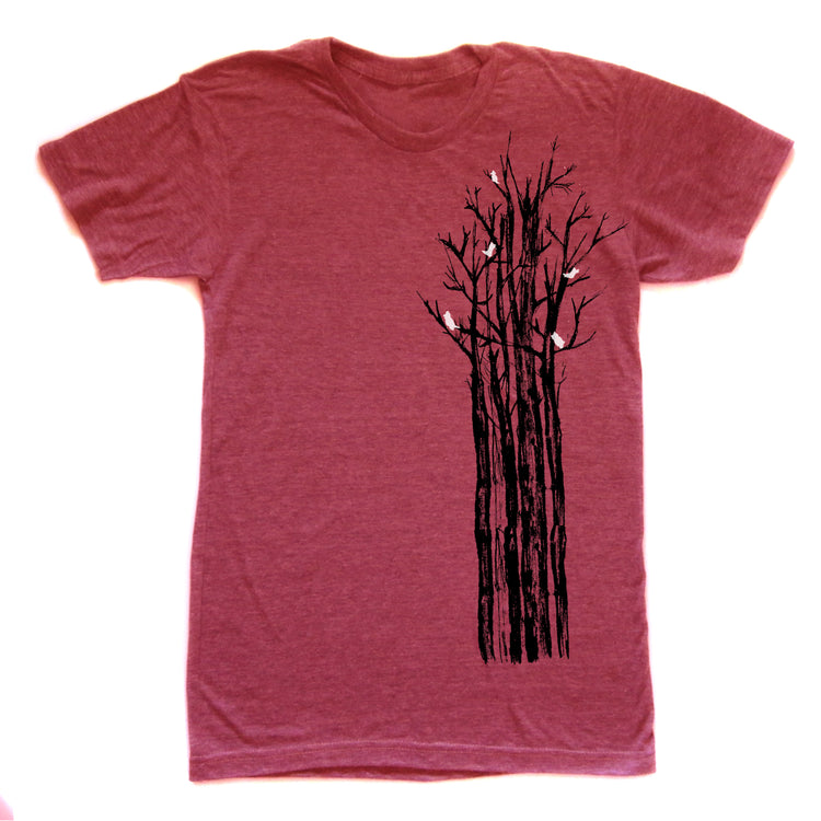 A red t-shirt with a graphic design depicting a tree with black branches and white birds perched on it.