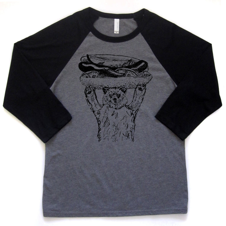 a gray and black baseball-style t-shirt with a graphic of a cat holding a hot dog on its head.