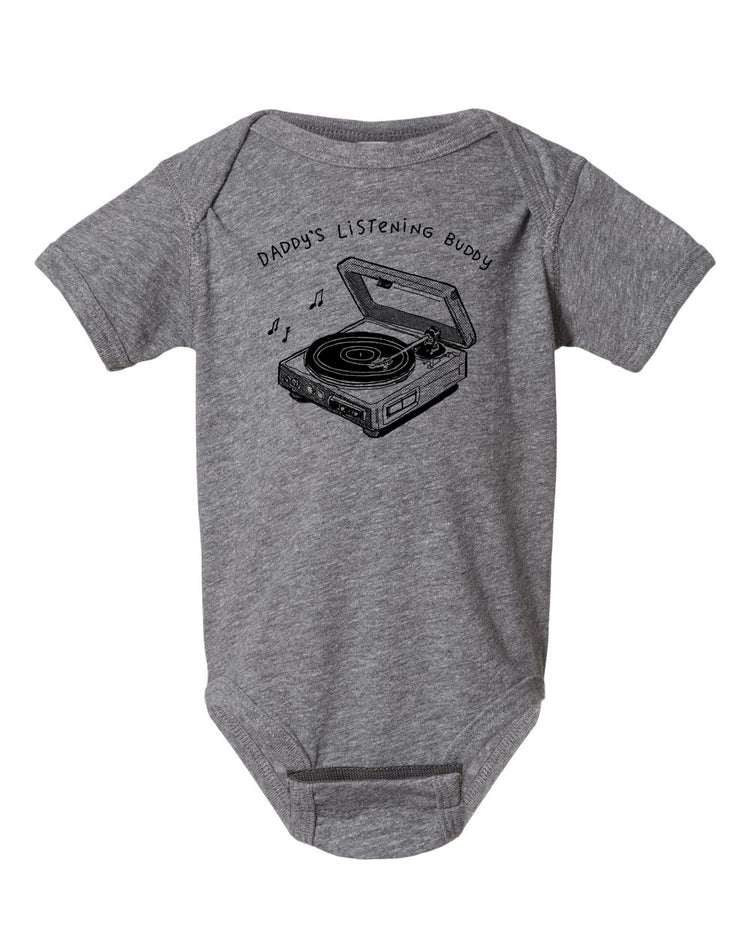 A gray baby onesie with a graphic design of a record player and the text "DADDA'S LISTENING BUDDY" printed on it.