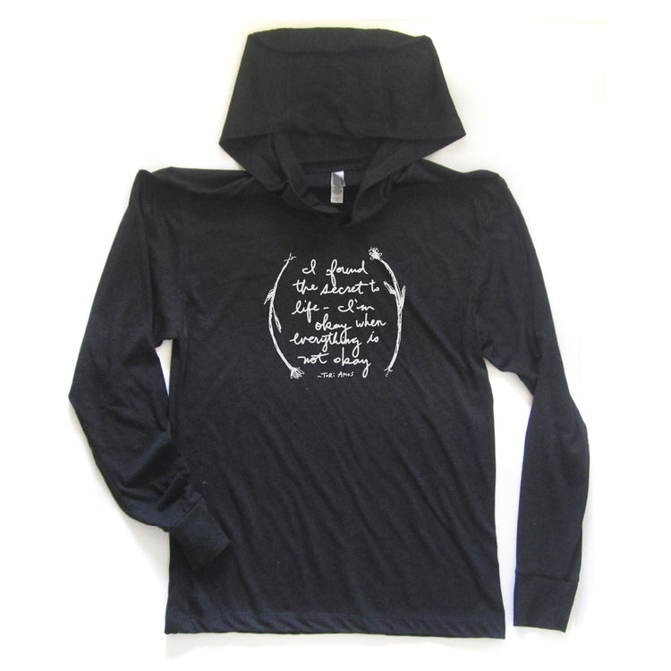 A black hooded long-sleeve t-shirt with a white text design on the front.