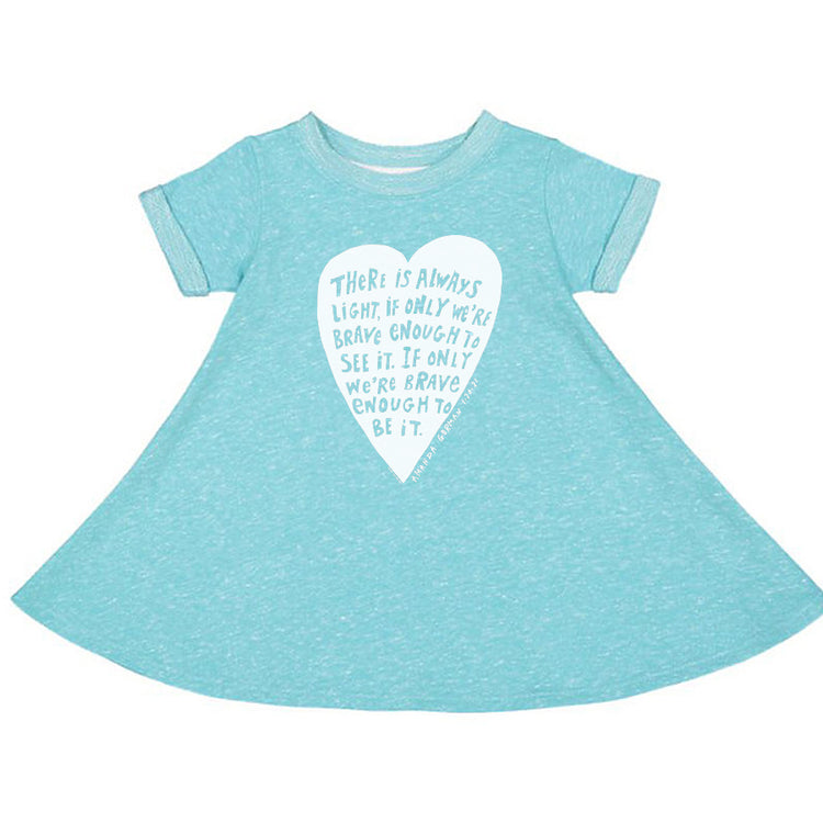 A light blue dress with a white heart-shaped graphic on the front, featuring a motivational quote about being brave and having light.