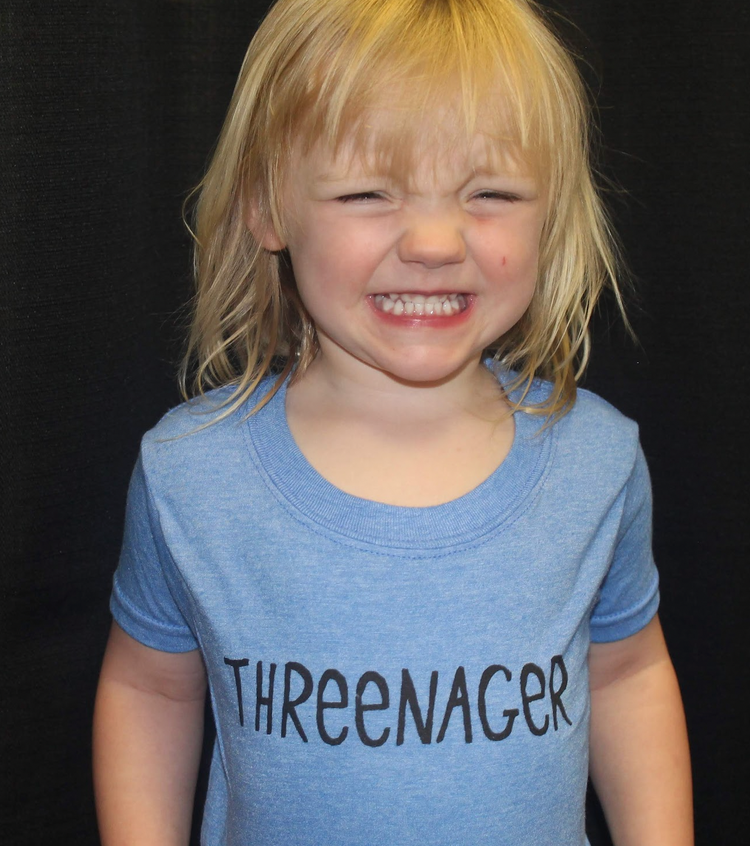 a little girl with a toothbrush in her mouth