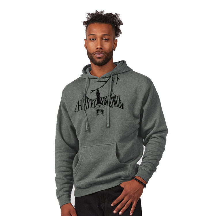 A man wearing a grey hoodie with a graphic design on it, standing against a white background.