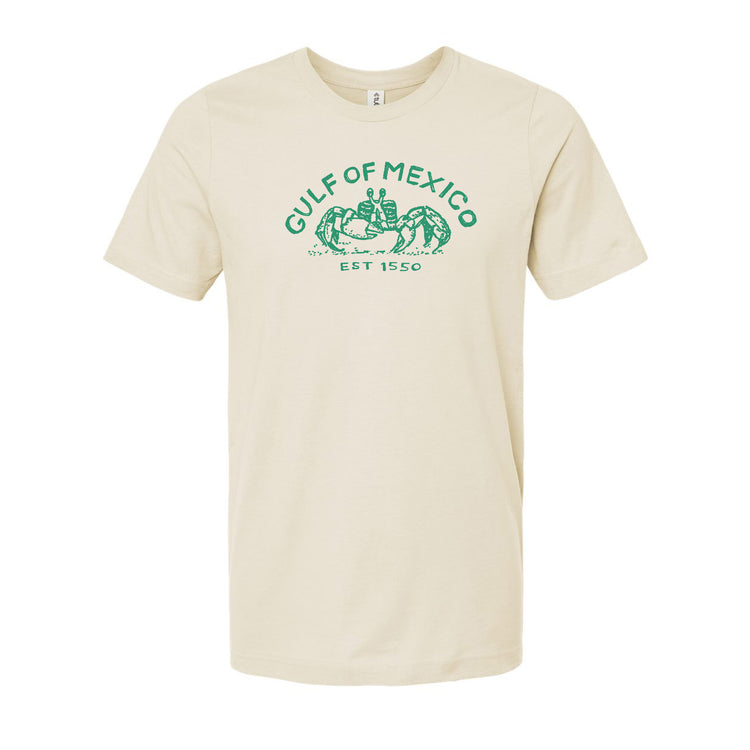 A beige t-shirt with a graphic design featuring a green crab and the text "Gulf of Mexico" and "EST 1550".