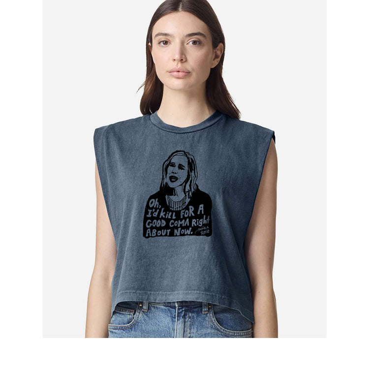 A woman wearing a gray sleeveless top with a graphic design and text printed on it.