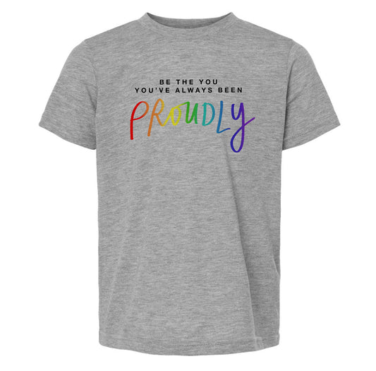 A gray t-shirt with the text "Be the you've always been Proudly" printed on it.