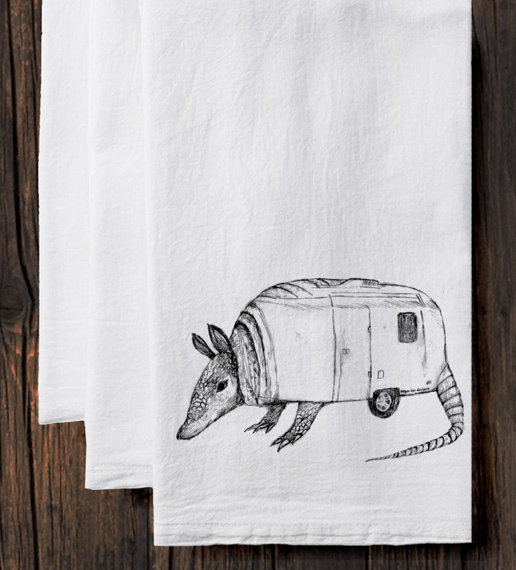 A hand-drawn illustration of an armadillo on a white towel.
