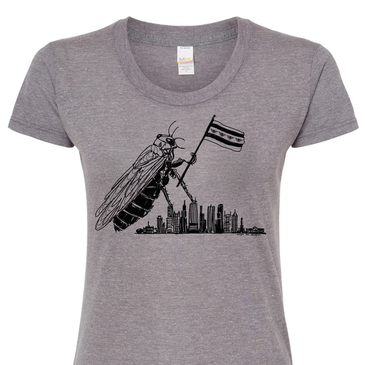 A gray t-shirt with a graphic design depicting a large insect holding a flag, with a city skyline in the background.