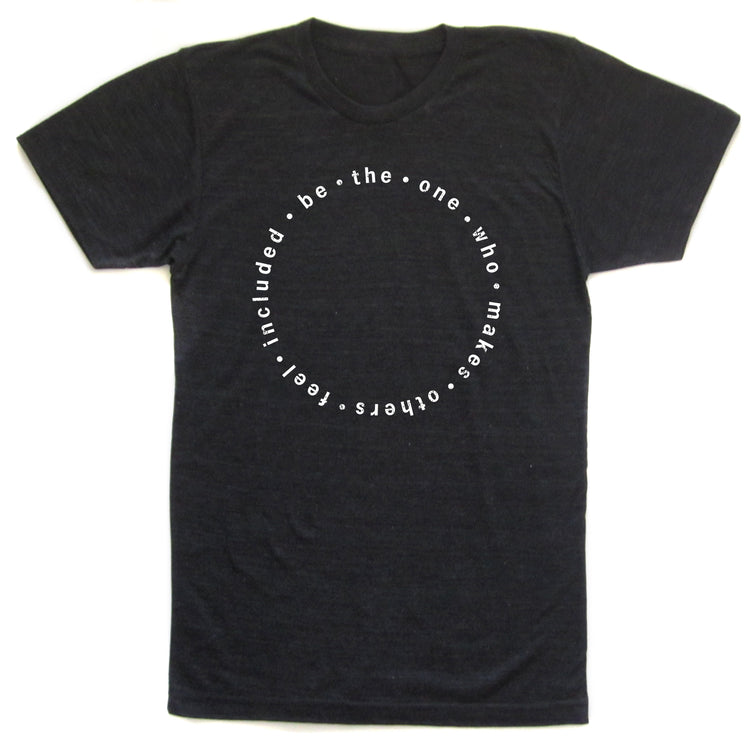A black t-shirt with a white circular design featuring the text "be - the - one - who - makes - others" arranged in a circular pattern.