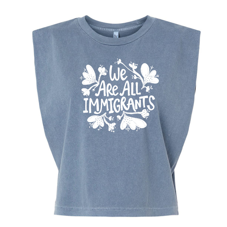 A gray t-shirt with a white graphic design that reads "We Are All Immigrants".