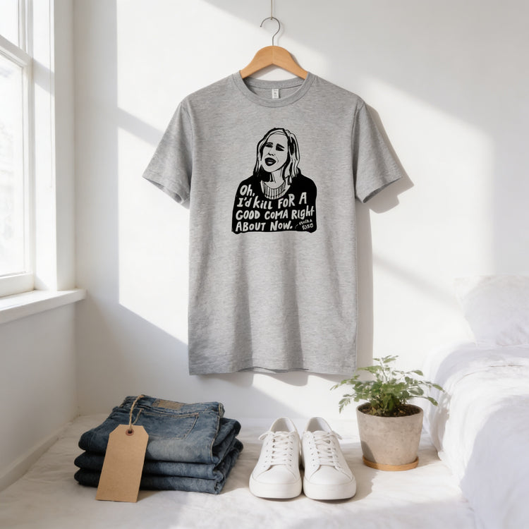 a gray t-shirt hanging on a wooden hanger, with a pair of jeans and a pair of white sneakers placed below it. There is also a potted plant and a tag visible in the scene.