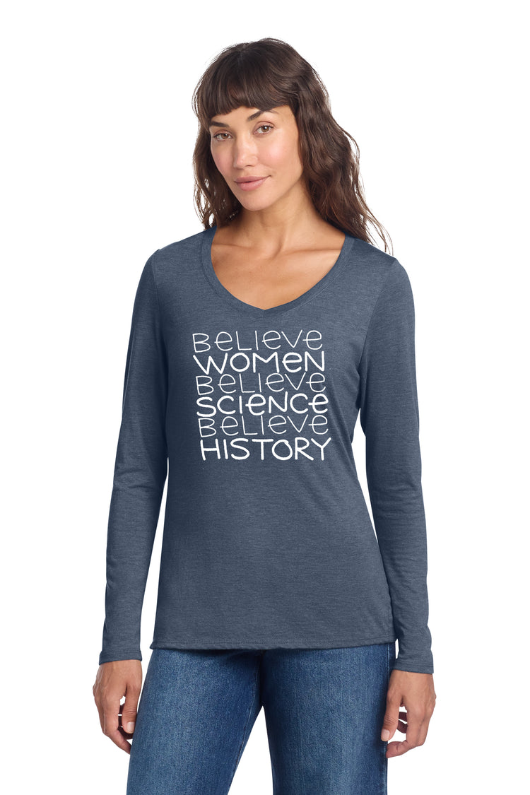 A woman wearing a gray long-sleeved shirt with white text printed on it.