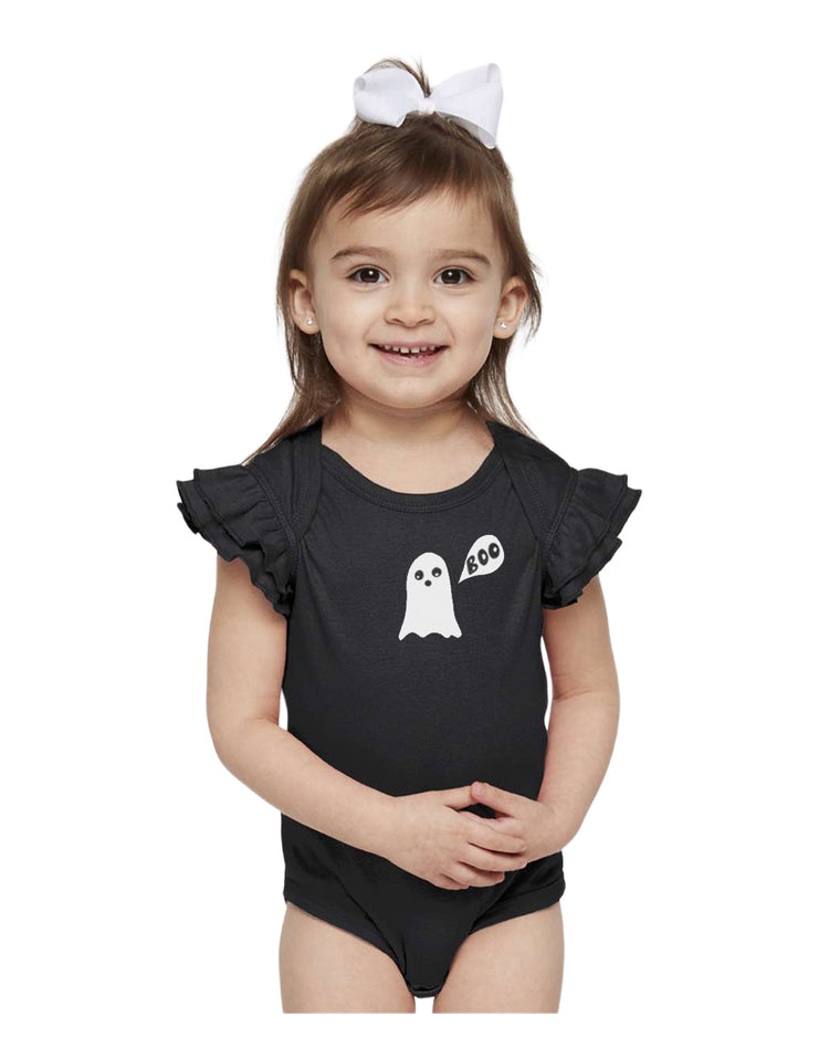 A young girl wearing a black ruffled bodysuit with a ghost design and a white bow in her hair.