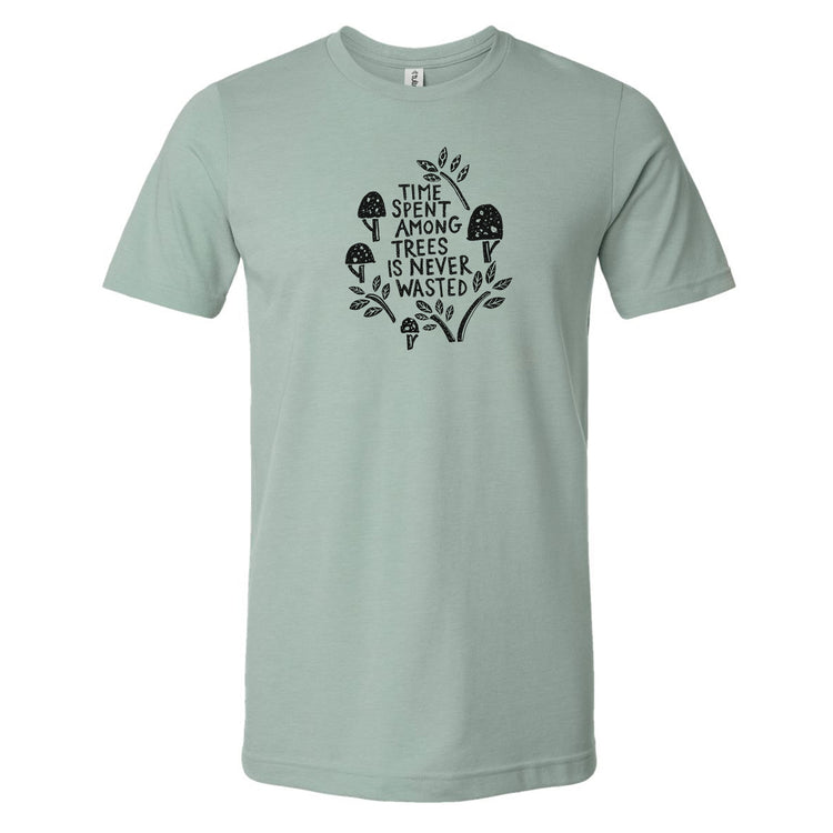 A light green t-shirt with a graphic design featuring a mushroom and leaves, along with the text "I spent among trees is never wasted".