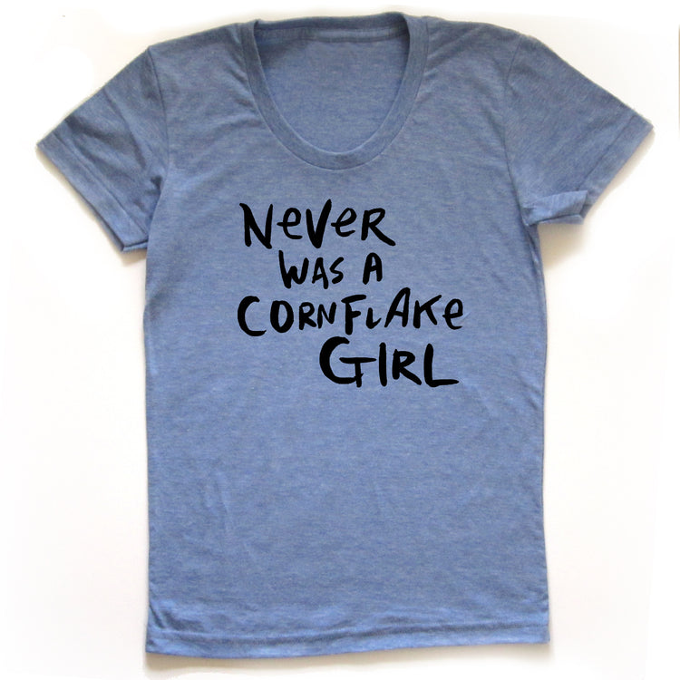 A light blue t-shirt with the text "Never was a Cornflake Girl" printed on it.
