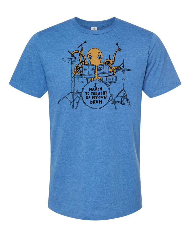 A blue t-shirt with an illustration of an octopus playing a drum set, accompanied by the text "I MUST reach to the BEAT of the DRUM".