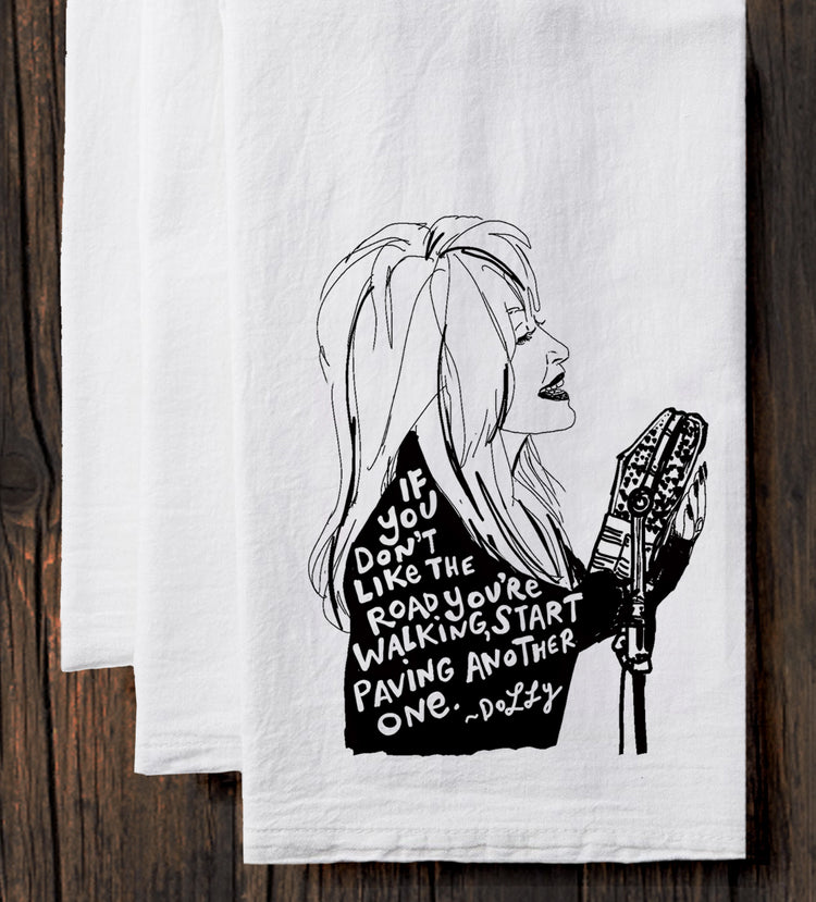 A black and white illustration of a woman with long hair holding a microphone, accompanied by text that reads "If you don't like the road you're walking, start walking another one."