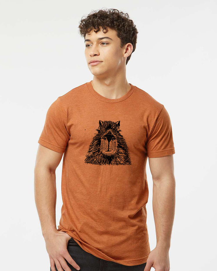 a man wearing an orange shirt with a bear on it
