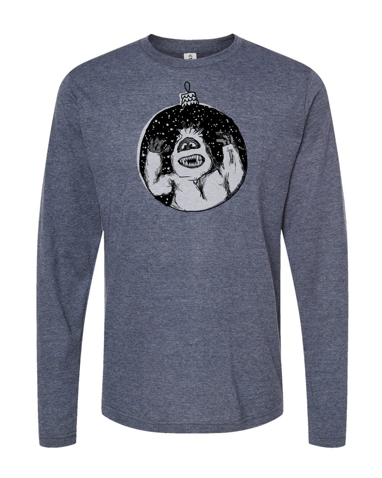 A gray long-sleeved t-shirt with a graphic design depicting a large, menacing-looking creature with sharp teeth and claws, surrounded by a circular frame with a starry background.
