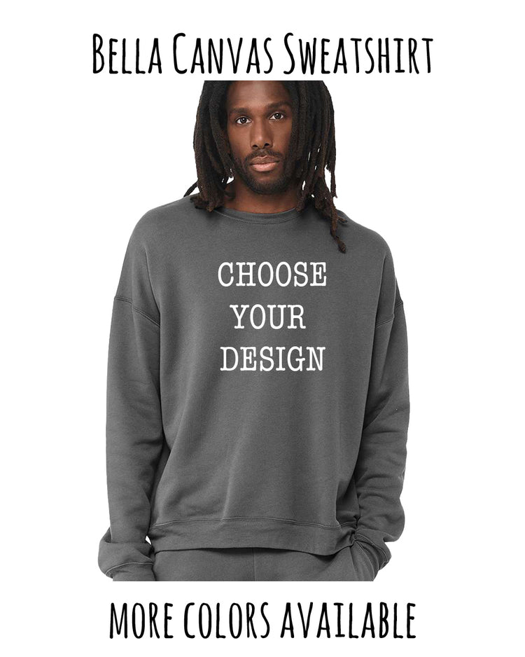 A man with dreadlocks wearing a gray sweatshirt with the text "Choose your design" printed on it.