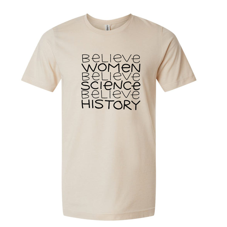 A beige t-shirt with the text "Believe Women Believe Science Believe History" printed on it in a bold, black font.