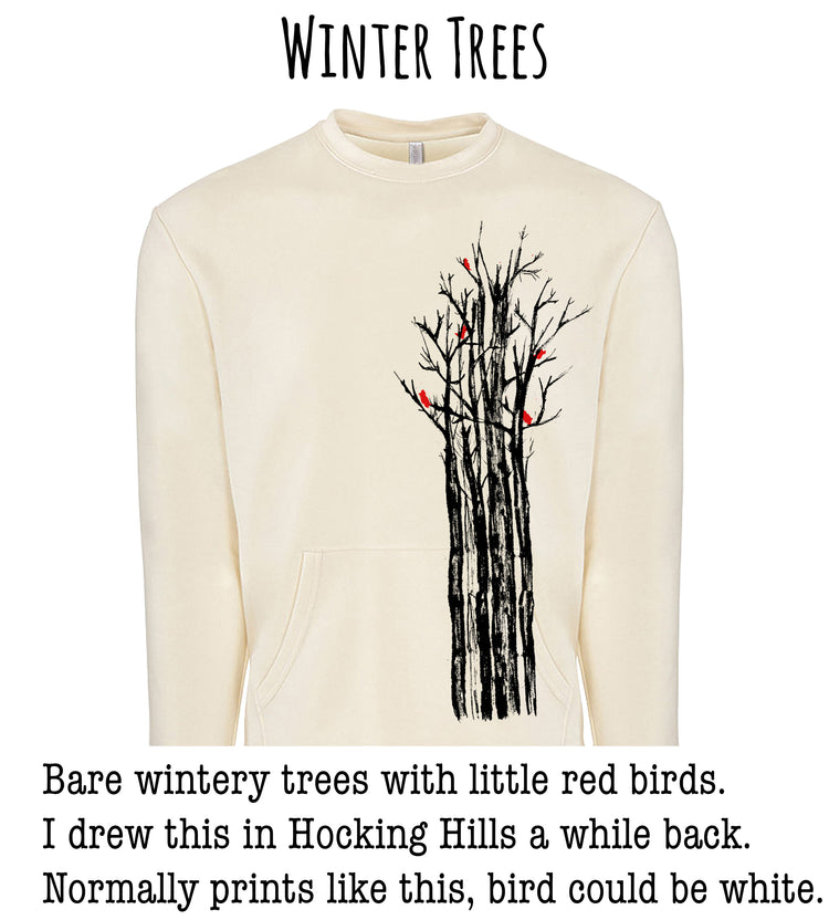 A white sweater with a graphic design depicting a group of bare winter trees with red birds perched on them.