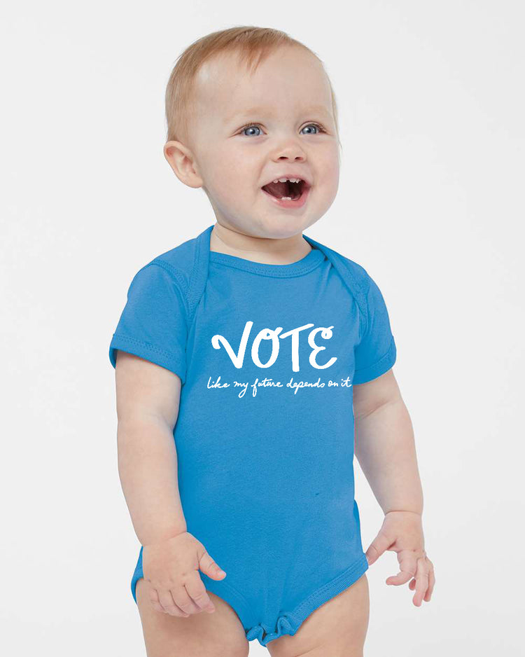 a baby wearing a blue vote bodysuit