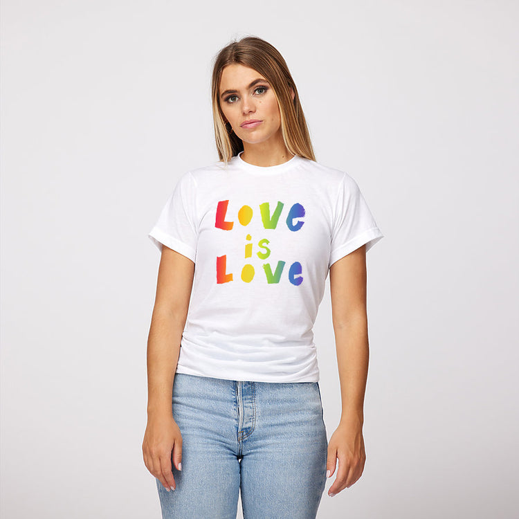 A woman wearing a white t-shirt with the text "LOVE is LOVE" printed on it.