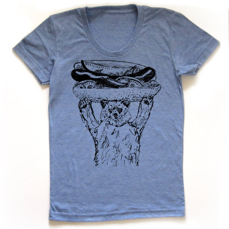 A blue t-shirt with a graphic design depicting a bear holding a hot dog on its head.
