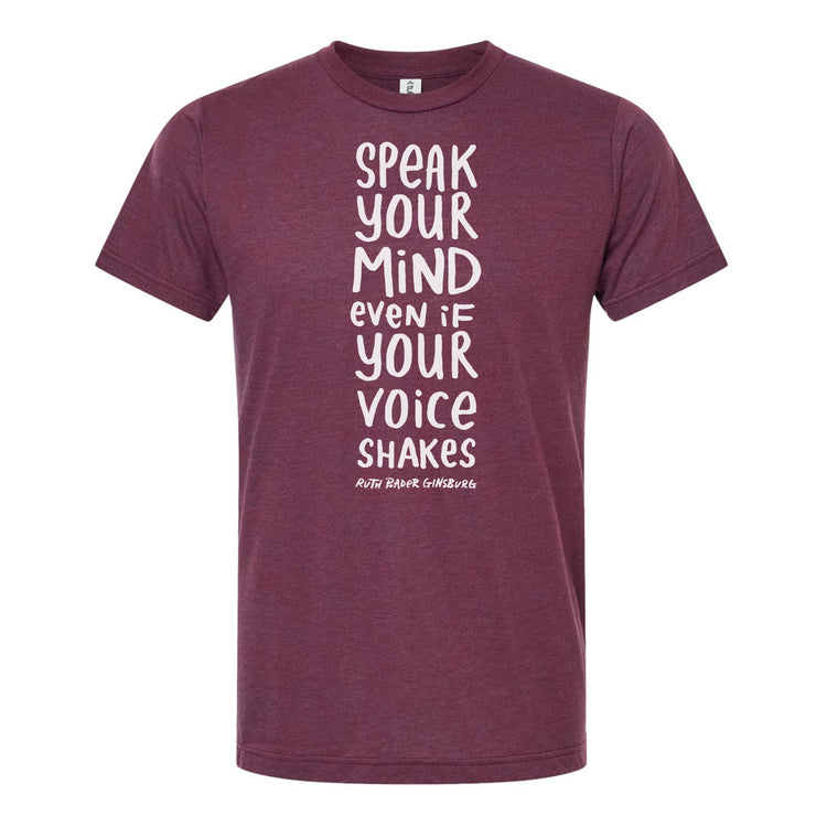 The image is a maroon t-shirt with white text printed on it. The text reads "Speak your mind even if your voice shakes".