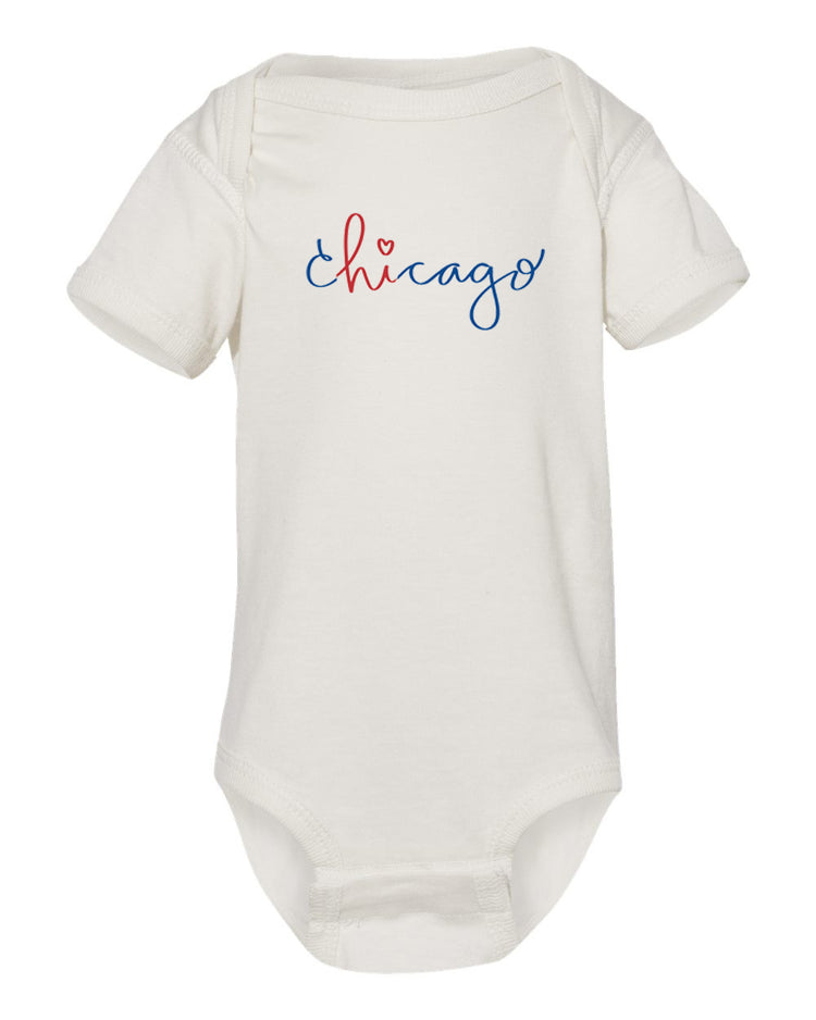 A white baby onesie with the word "Chicago" written in blue cursive text across the front.