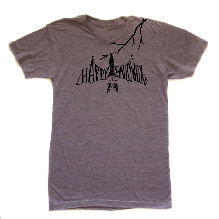 A gray t-shirt with a graphic design featuring a bat hanging upside down from a branch with the text "HAPPY HALLOWEEN" printed on it.