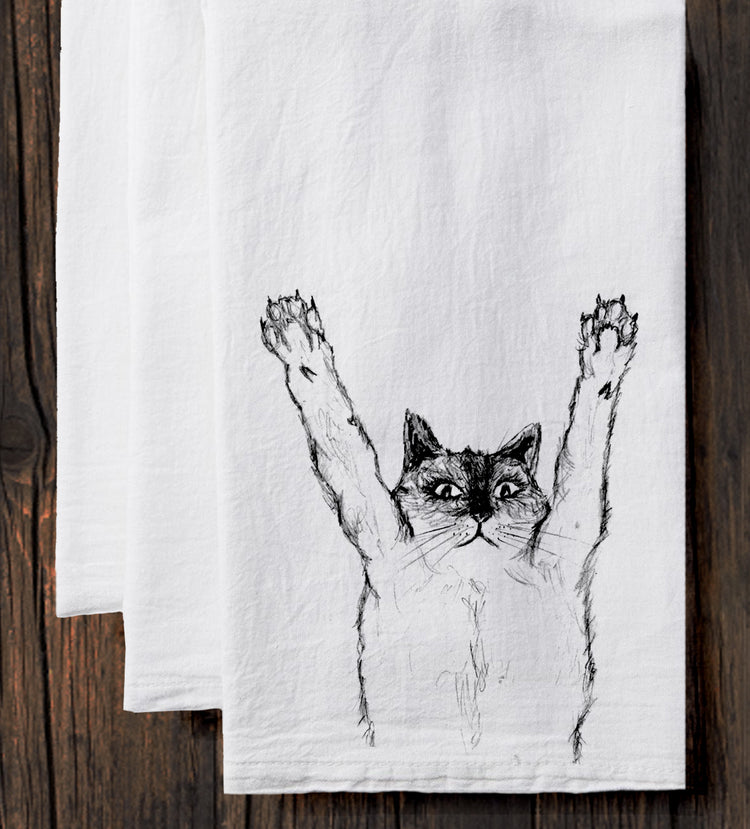 A white towel with a black and white illustration of a cat with its paws raised in the air.