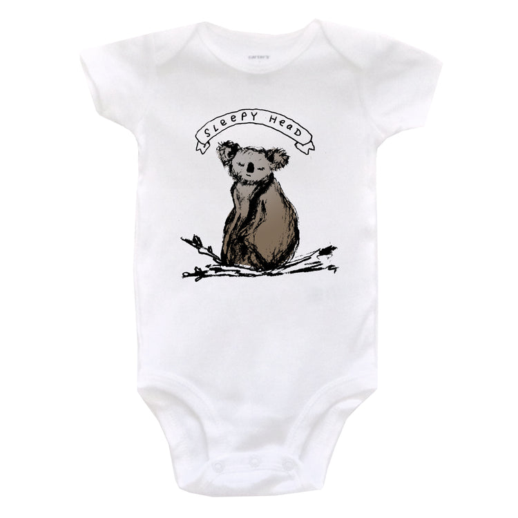 A white baby onesie with a graphic of a koala bear and the text "SLEEPY HEAD" printed on it.