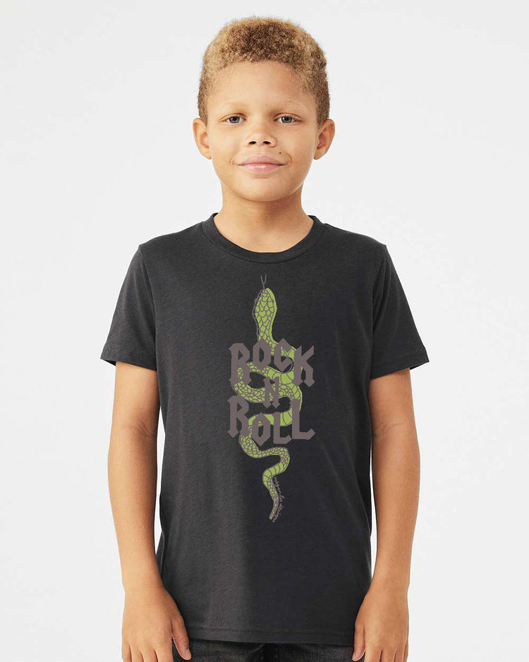 A young boy wearing a black t-shirt with a graphic design of a green snake and the text "Rock on Roll" printed on it.