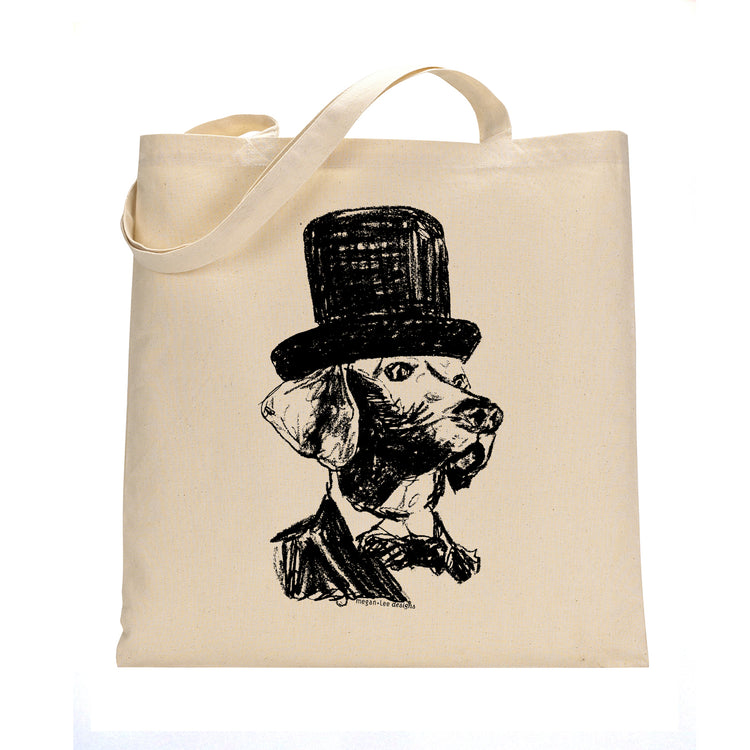 A beige tote bag with a black and white illustration of a dog wearing a top hat.