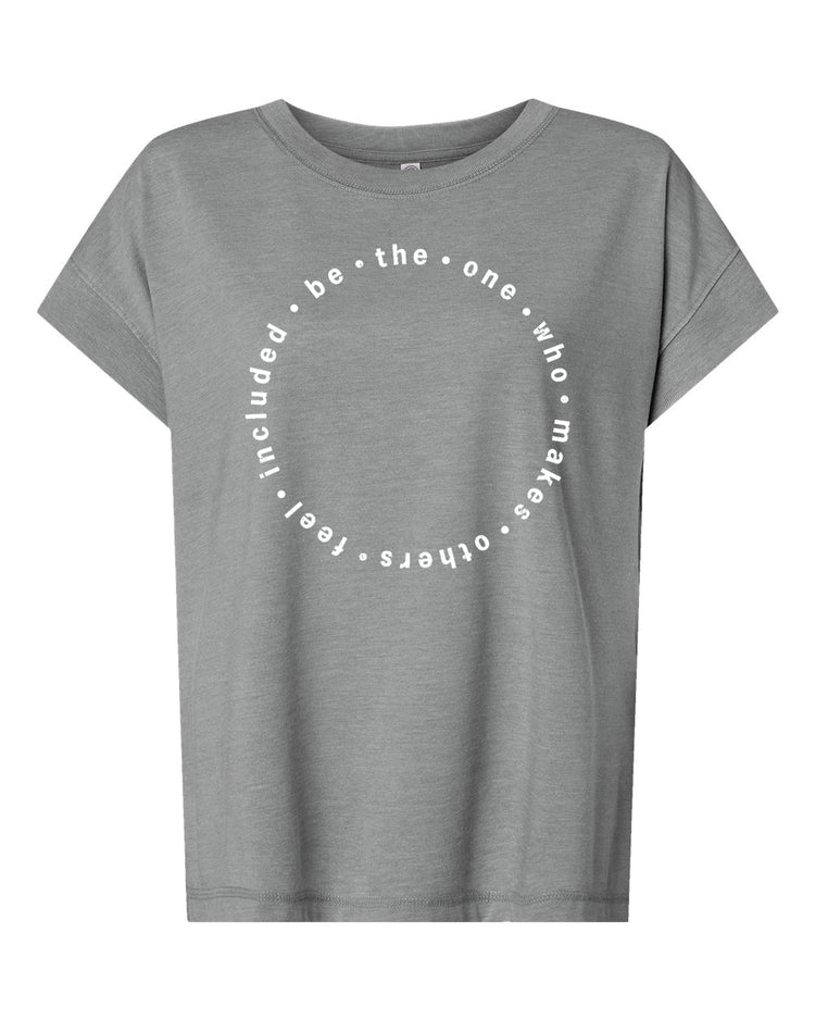 A gray t-shirt with a circular design featuring the text "be the one who makes others feel free" printed on it.