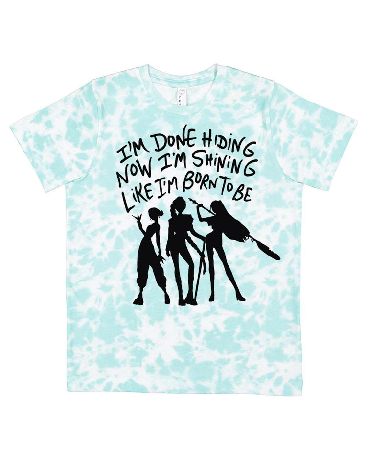 A light blue tie-dye t-shirt with a graphic design featuring silhouettes of three people and text that reads "I'm done hiding now I'm shining like I'm born to be".
