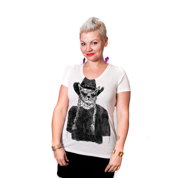 A woman wearing a white t-shirt with a graphic of a cat wearing a cowboy hat and sunglasses.