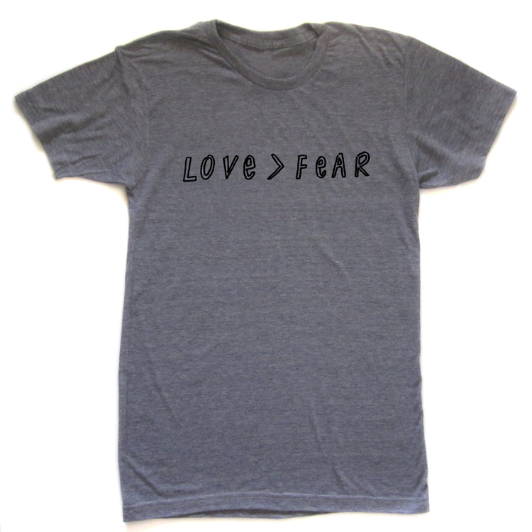 A gray t-shirt with the text "LOVE > FEAR" printed on it.