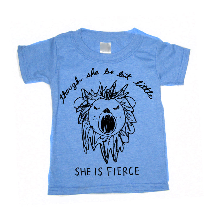 A light blue t-shirt with a black and white illustration of a lion's head and the text "Though she be but little, she is fierce" printed on it.