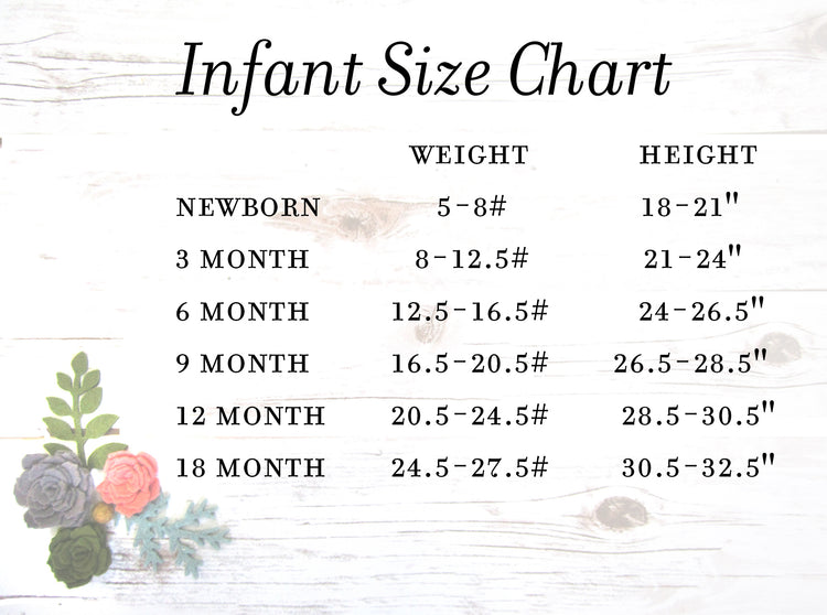 a white wooden table topped with flowers and a sign