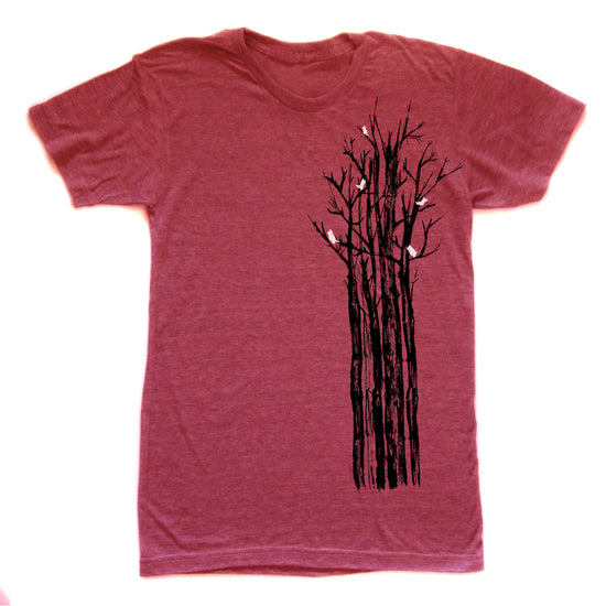A red t-shirt with a graphic design depicting a tree with black branches and white birds perched on it.