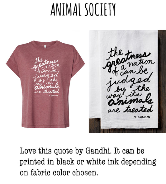 a pink t-shirt with a quote from Mahatma Gandhi and a white towel with a quote from Gandhi. The quote is about the importance of treating animals with respect and compassion. The quote can be printed in black or white ink depending on the fabric color chosen for the t-shirt.