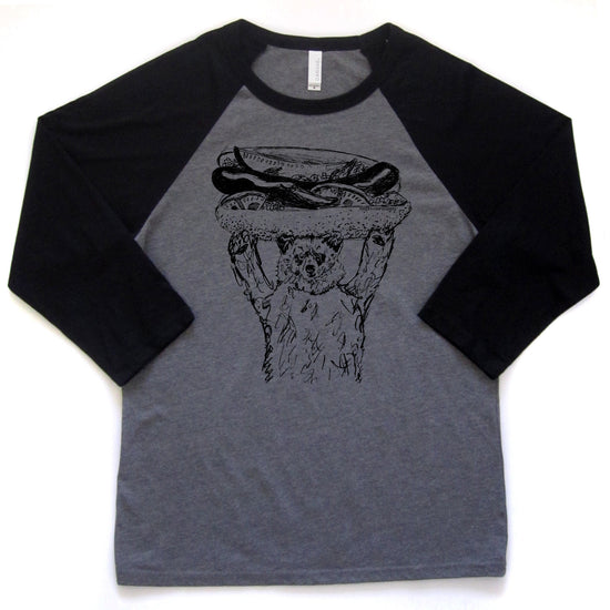 a gray and black baseball-style t-shirt with a graphic of a cat holding a hot dog on its head.
