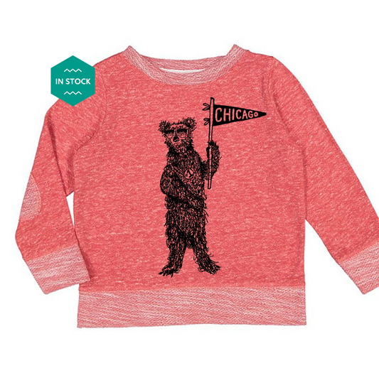 a red shirt with a bear holding a sign