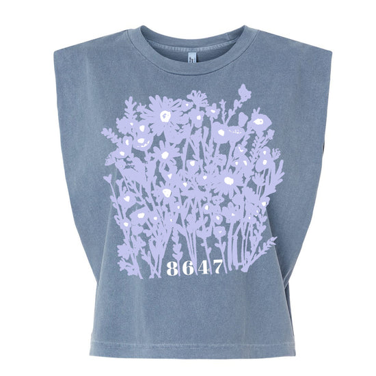 A gray t-shirt with a graphic design of purple flowers and the number "8647" printed on it.