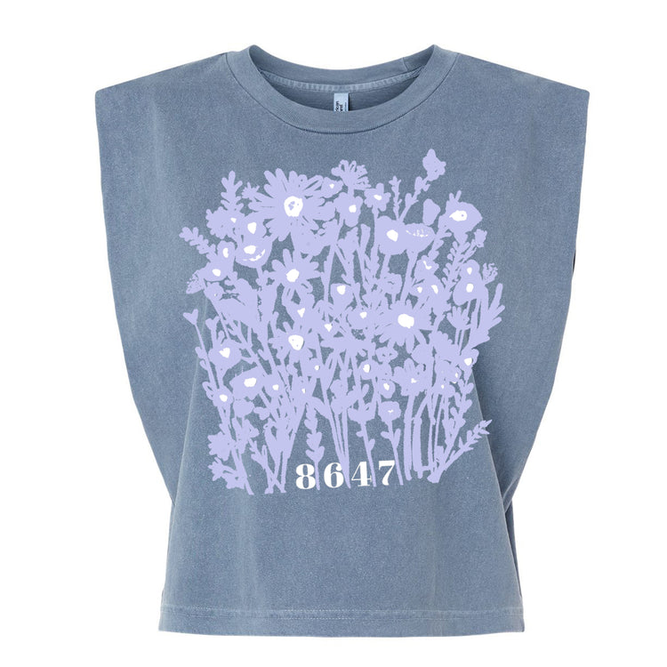 A gray t-shirt with a graphic design of purple flowers and the number "8647" printed on it.