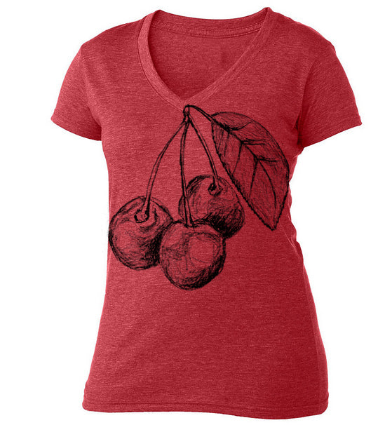 A red t-shirt with a black and white illustration of cherries and a leaf on it.