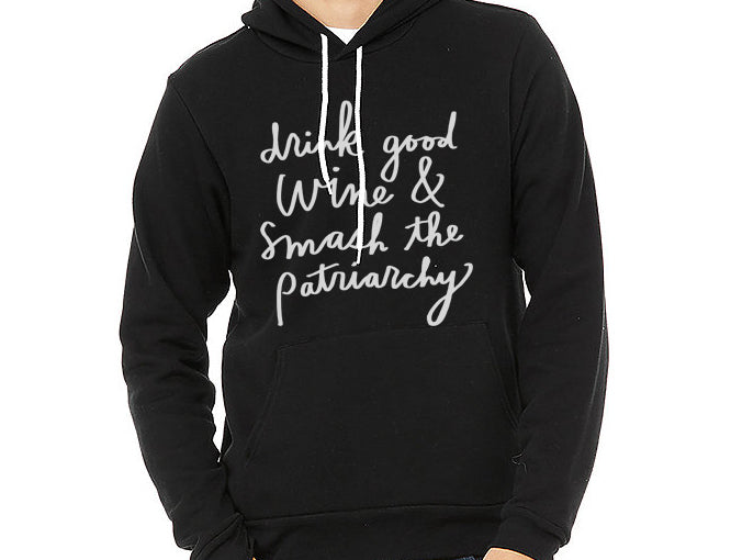 A person wearing a black hoodie with white text printed on it.